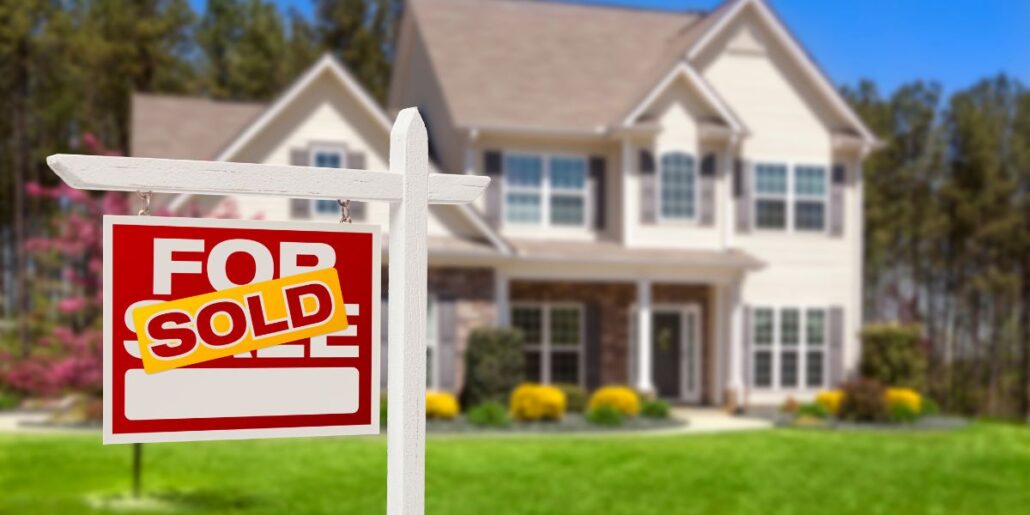 home with for sale sign sold